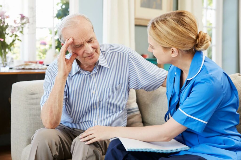 A healthcare professional assessing an older adult's care needs to help choose the right dementia care community.