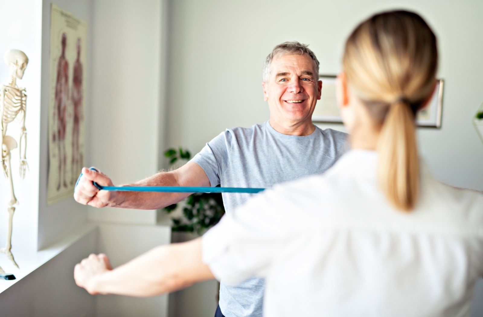 A physical therapist works with a senior during a rehabilitation session.